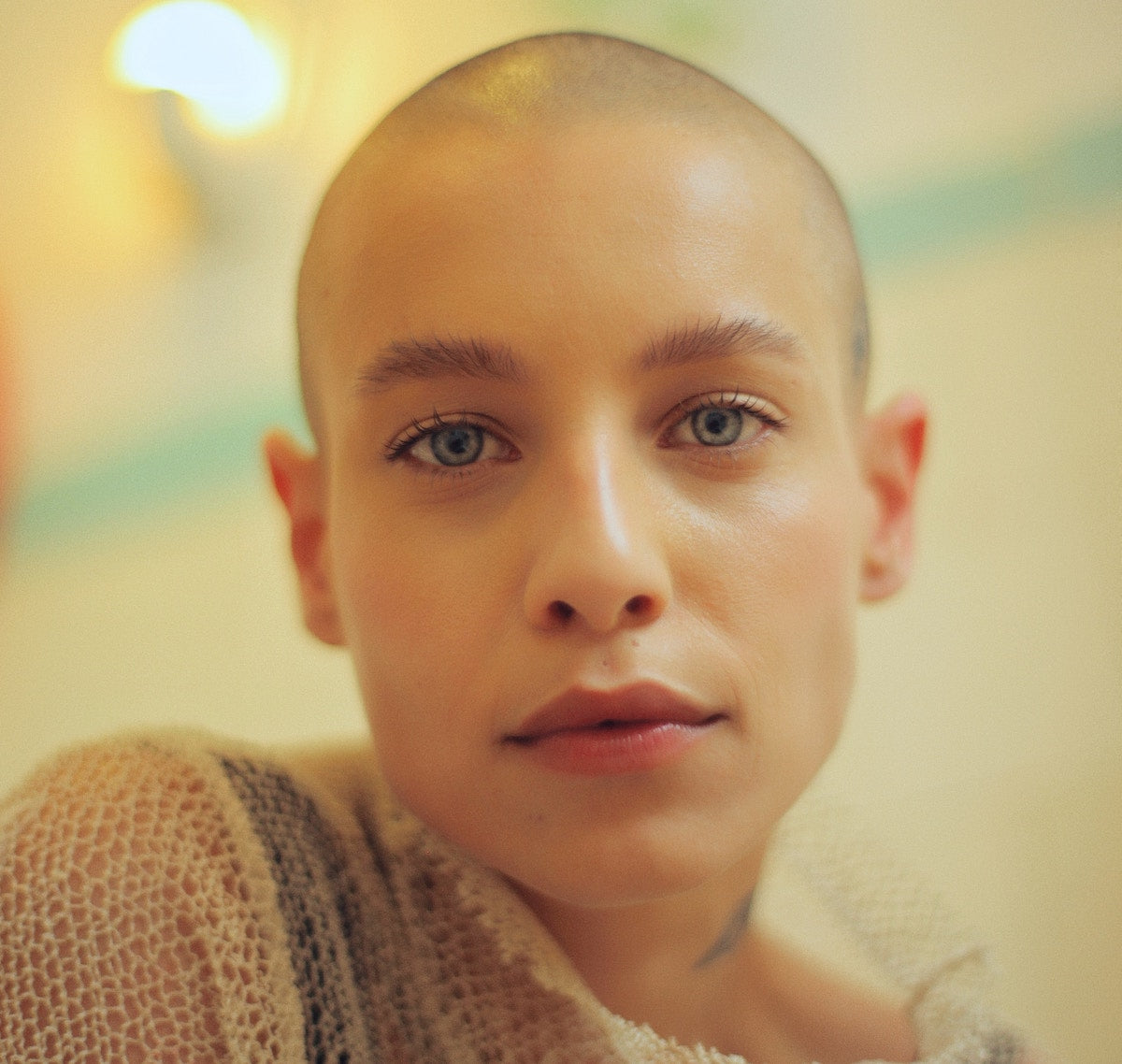 beautiful woman with dewy skin and shaved head