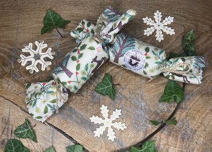 christmas cracker set on oak background with ivy decorations